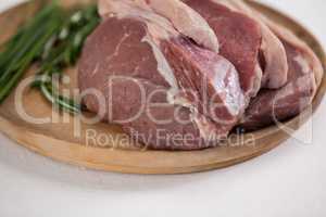Sirloin chop and rosemary herb on wooden tray