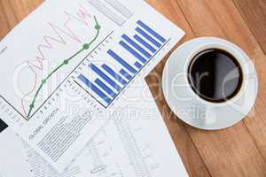 Coffee cup and graph document