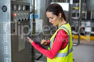 Female factory worker using digital tablet