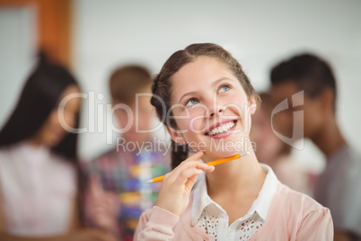 Smiling schoolgirl looking up in classroom