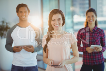 Portrait of business executives using mobile phone and digital tablet