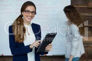 Portrait of smiling businesswoman using digital tablet