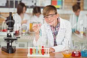 Portrait of schoolboy doing a chemical experiment in laboratory