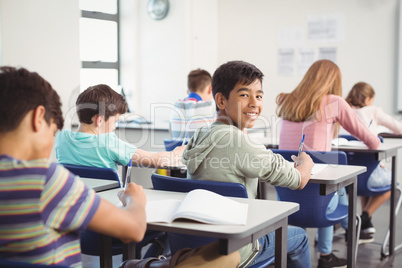 School kids doing homework in classroom