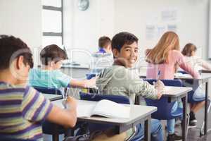 School kids doing homework in classroom