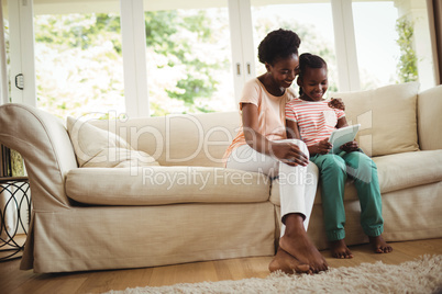 Mother and daughter using digital tablet