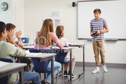 Schoolboy giving presentation in classroom