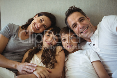 Parents and kids sitting on the bed