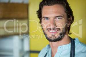 Smiling male staff standing in health grocery shop