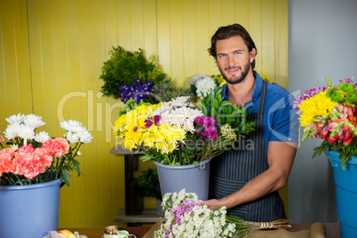 Happy florist holding bucket of flower