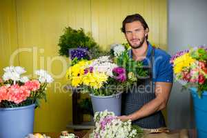 Happy florist holding bucket of flower