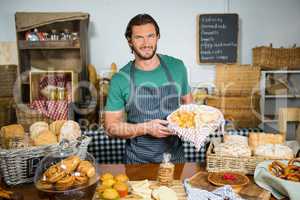 Staff holding bakery snacks at counter