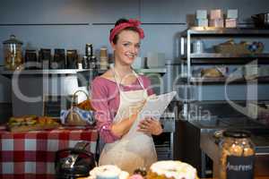 Portrait of staff maintaining records on clipboard