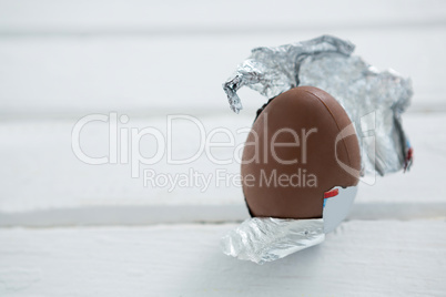 Chocolate Easter egg in foil on white background