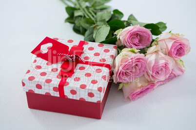 Gift box with bunch of rose on white background