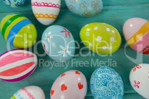 Painted Easter eggs on wooden plank