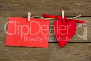 Red hearts and envelope with cloth peg hanging on rope