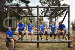 Fit people sitting on the obstacle couse