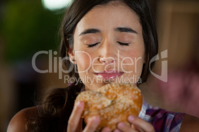 Smiling woman smelling a bread at counter
