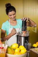 Shop assistant preparing fruit juice
