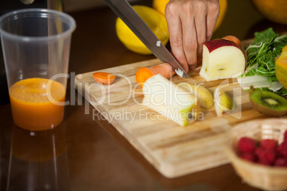 Staff chopping carrot at counter