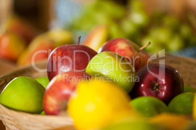 Close-up of fresh apples in wicker basket at organic section