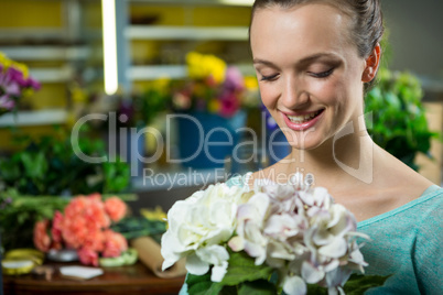 Smiling woman holding a bunch of flowers