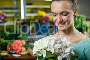 Smiling woman holding a bunch of flowers