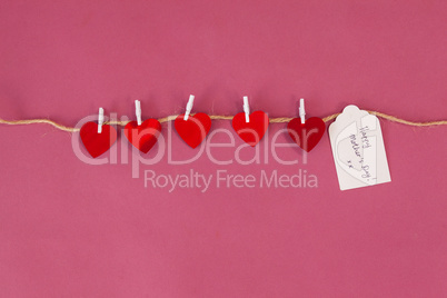Happy mothers day card and red hearts hanging on rope