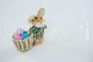 Basket with Easter eggs and toy Easter bunny