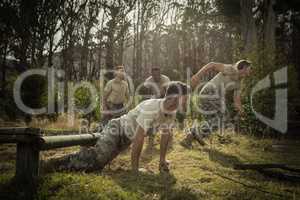 Soldiers crawling under the net during obstacle course