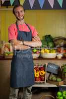 Portrait of male staff standing with arms crossed in organic section