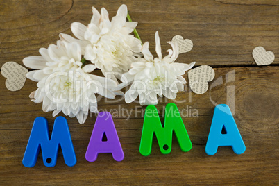 Heart shape with alphabet reading mama and white flowers