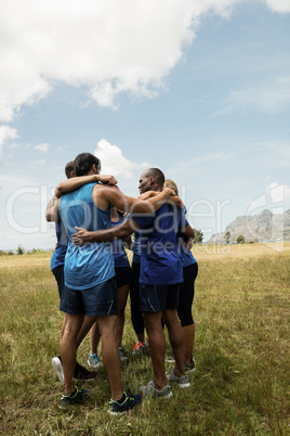 Fit people standing together and forming a hurdle