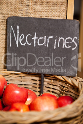 Close-up of fresh nectarines with placard in organic section