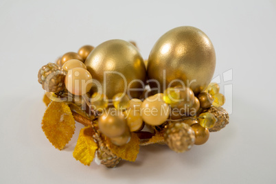 Golden Easter eggs in decorated basket