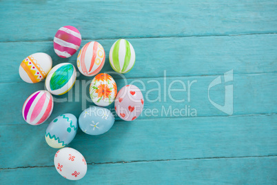 Painted Easter eggs on wooden surface