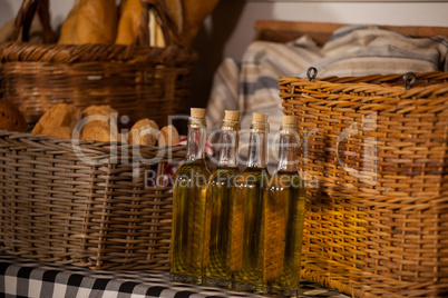 Sesame oil and bread in wicker basket