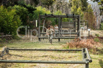 Soldier running through obstacle course