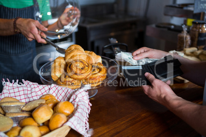 Customer making payment to staff at counter