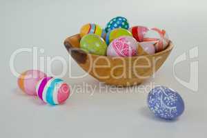 Colorful Easter eggs in wooden bowl