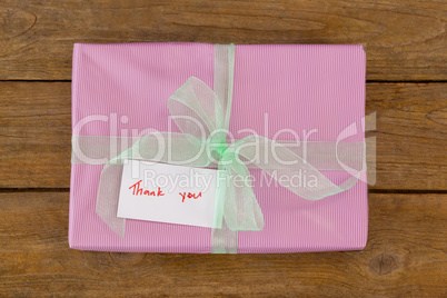 Thank you card with gift box on table