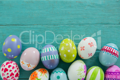 Painted Easter eggs on wooden surface