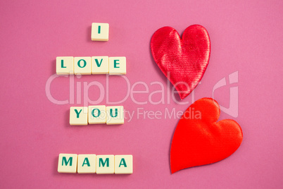 Red heart next to white blocks displaying I love you mama message