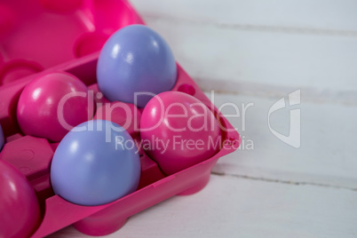 Multicolored Easter eggs in the carton
