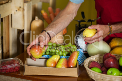 Staff arranging vegetables at counter in market
