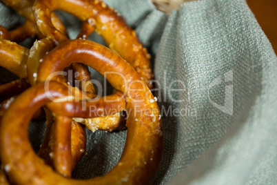 Close-up of pretzel breads in wicker basket at counter
