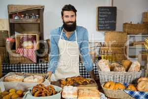 Portrait of male staff standing at bakery counter