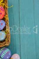 Various Easter eggs arranged in wicker basket