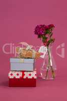 Stack of gift boxes and flowers vase